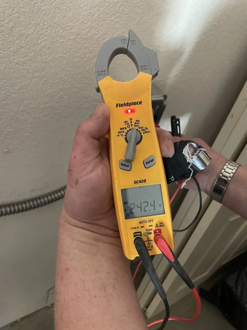 Voltage testing with clamp meter during Ceiling Fan Installation in Woonsocket